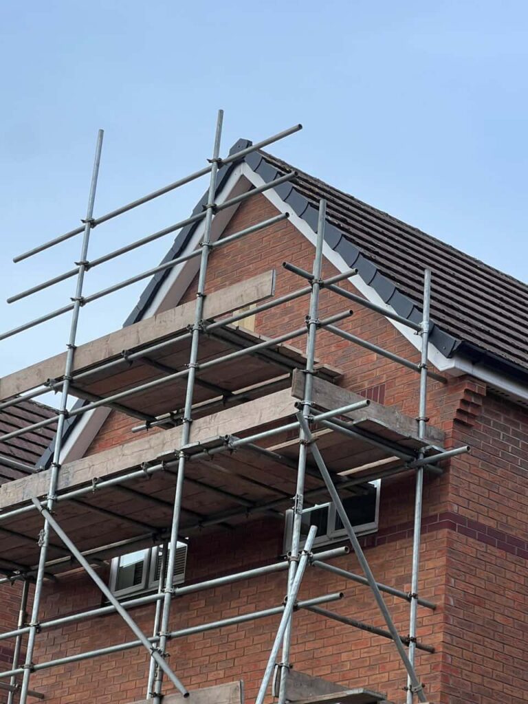 This is a photo of a roof which has just been repaired. There is a scaffold located at the gable end for access onto the roof. Works carried out by Bilston Roofing Repairs
