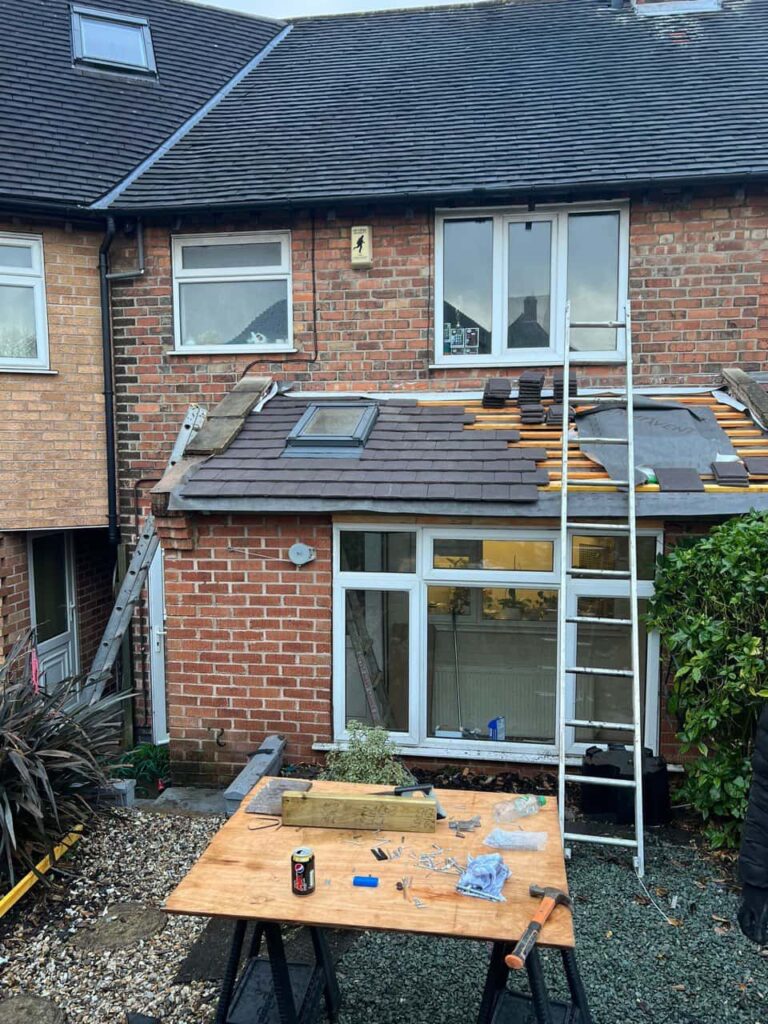  This is a photo taken from the roof ridge looking down a tiled pitched roof on to a flat roof. Works carried out by Bilston Roofing Repairs